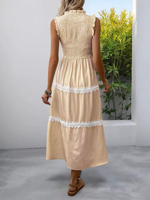 Yellow striped midi dress with smocked bodice, tiered skirt, and lace trim.