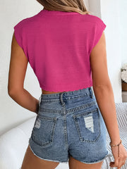 Hot pink scalloped crochet crop top with cap sleeves and a ribbed knit texture.