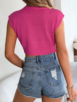 Hot pink scalloped crochet crop top with cap sleeves and a ribbed knit texture.
