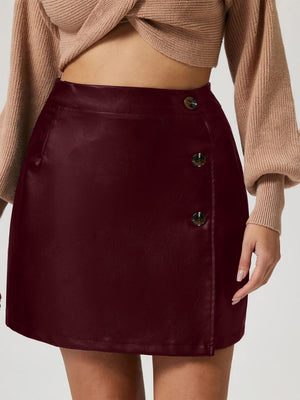 Burgundy faux leather asymmetric button-front mini skirt with a casual cut.