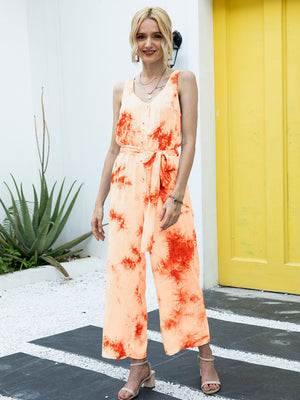 Orange tie-dye button-down jumpsuit with tie waist and wide legs.