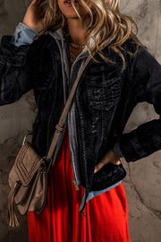 Black denim jacket with grey hooded layer, zip front, chest pockets, and distressed details.