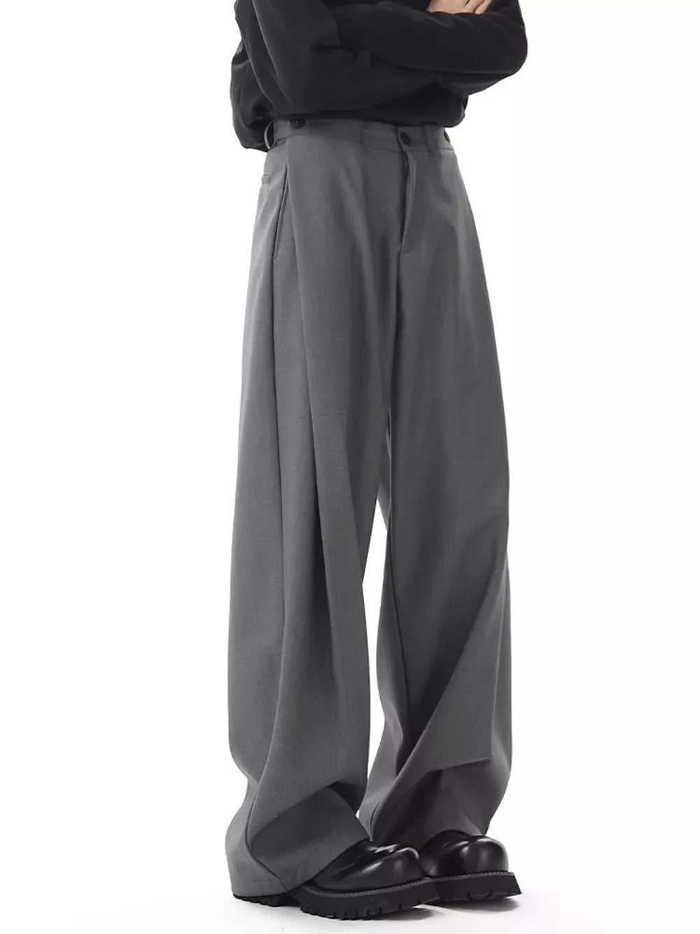 Men's dark gray flowy wide-leg sweatpants with pleats and button closure.