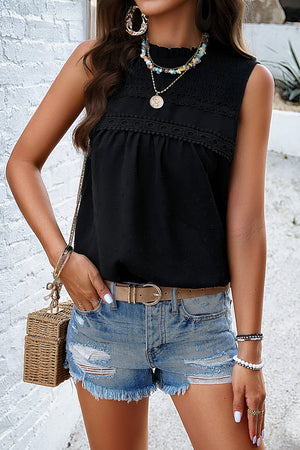 Black textured yoke dot tank top with smocked neckline and lace trim.