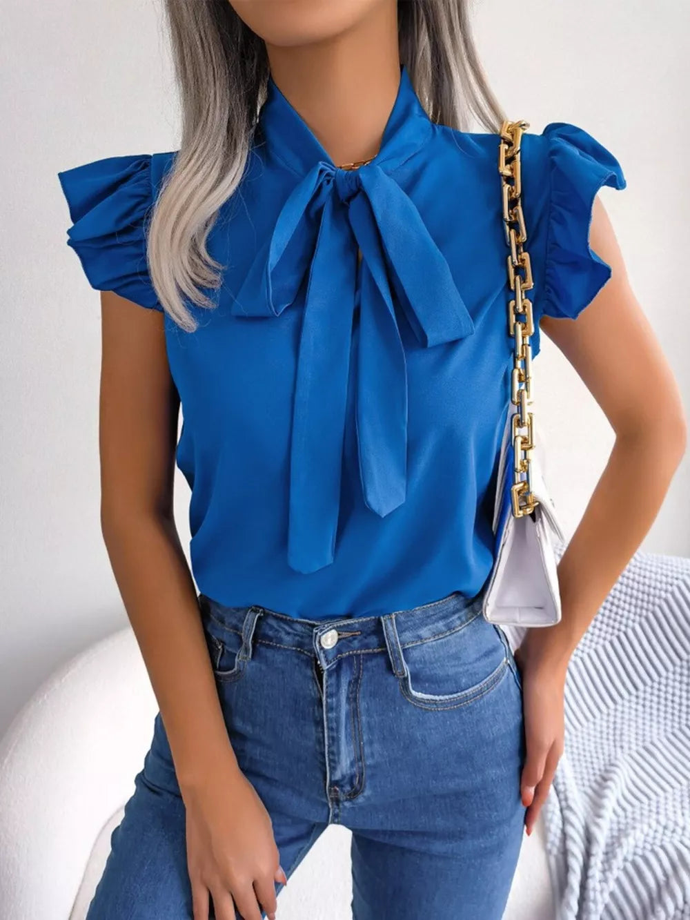 Royal blue pussy-bow ruffle sleeve maternity blouse with a tie neck.