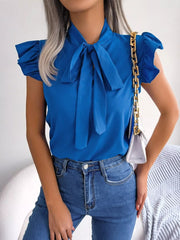 Royal blue pussy-bow ruffle sleeve maternity blouse with a tie neck.