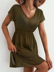 Green sheer mini dress with V-neck, short sleeves, elastic waist, and side slit.