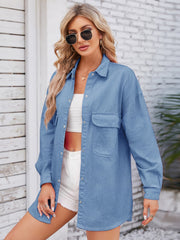 Oversized denim overshirt in dusty blue with two chest pockets and a back pleat detail.