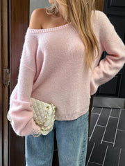 Blush pink ribbed knit one-shoulder sweater with relaxed fit and balloon sleeves.