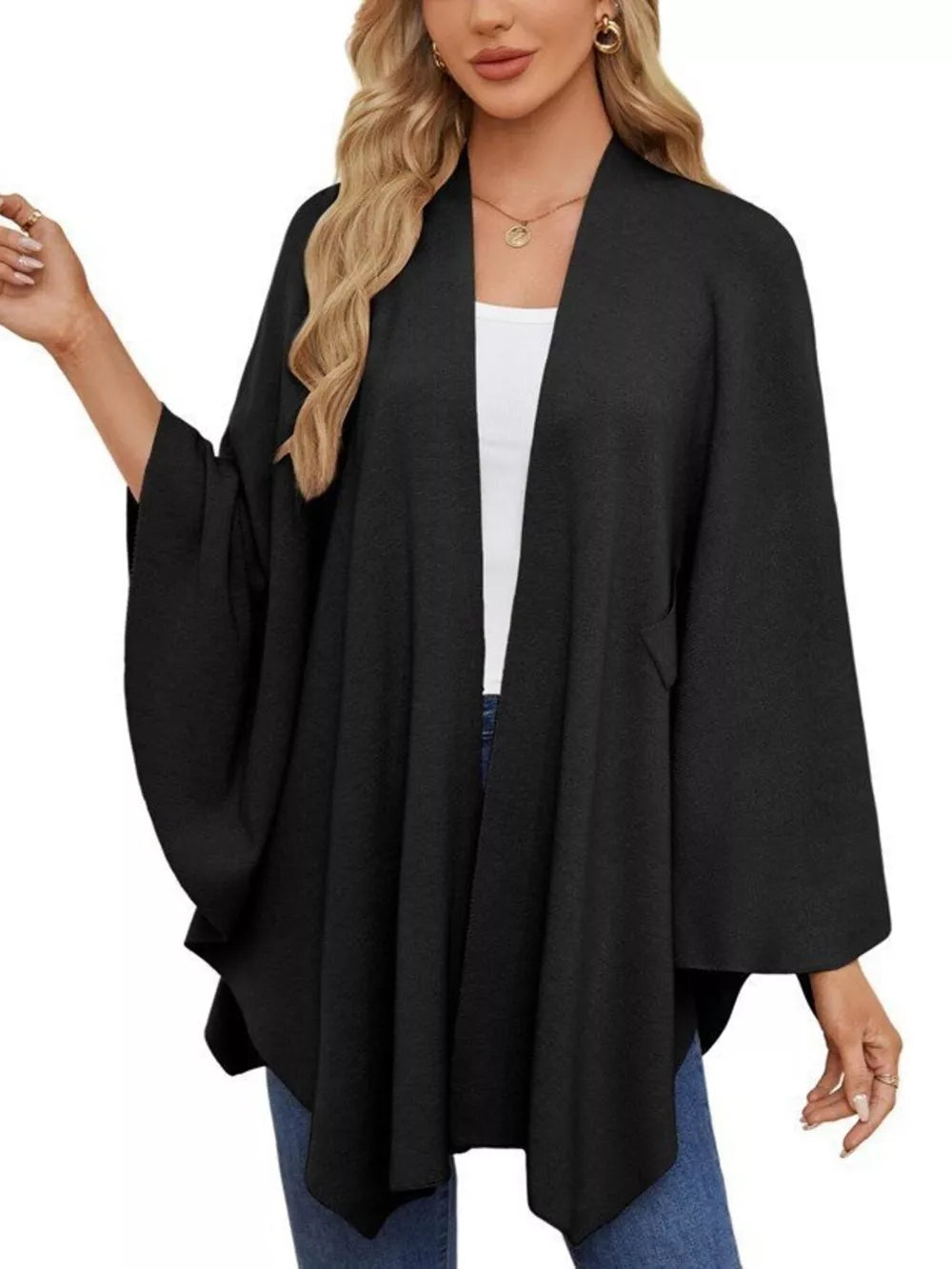 Black knit cape top with draped elegance and open front.