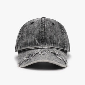 Acid wash distressed baseball cap in black denim with frayed brim detail.