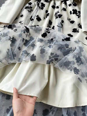 Maternity midi dress with sheer floral overlay and matching blazer.