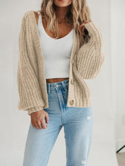 Camel knit cardigan with voluminous sleeves and button front.