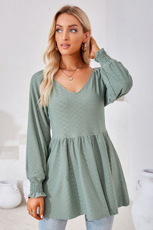 Sage textured babydoll blouse with v-neck and smocked cuffs