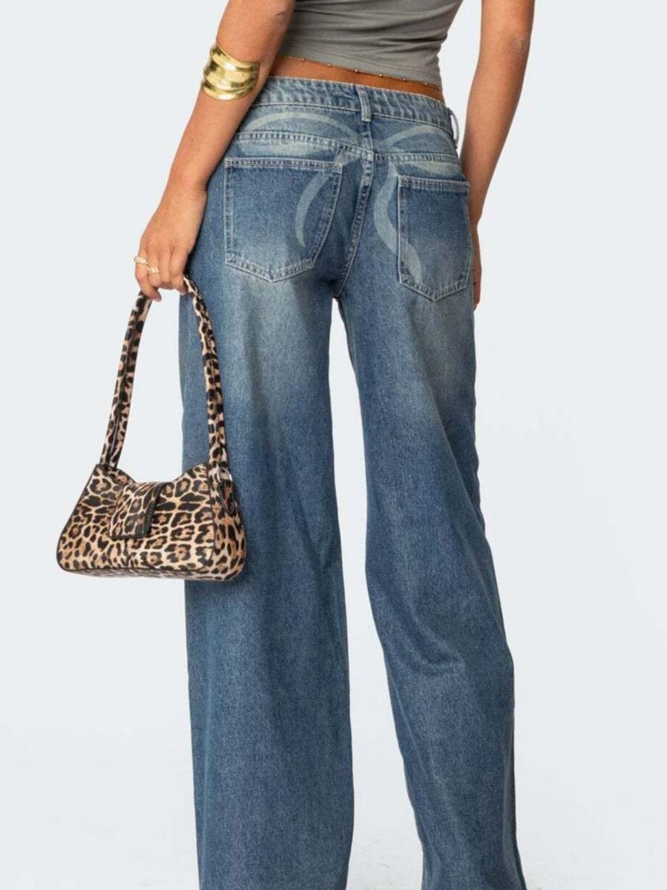 Dark blue wide leg denim jeans with subtle pocket detail and a leopard print shoulder bag.