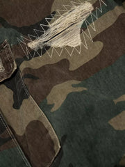 Distressed camouflage cargo pants with visible white zig-zag stitching and frayed details.
