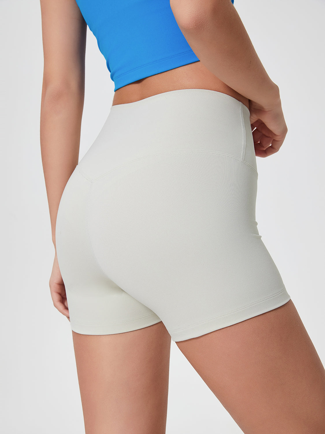 Nova Rise High-Motion Shorts in light gray, seamless activewear shorts with a v-seam detail.
