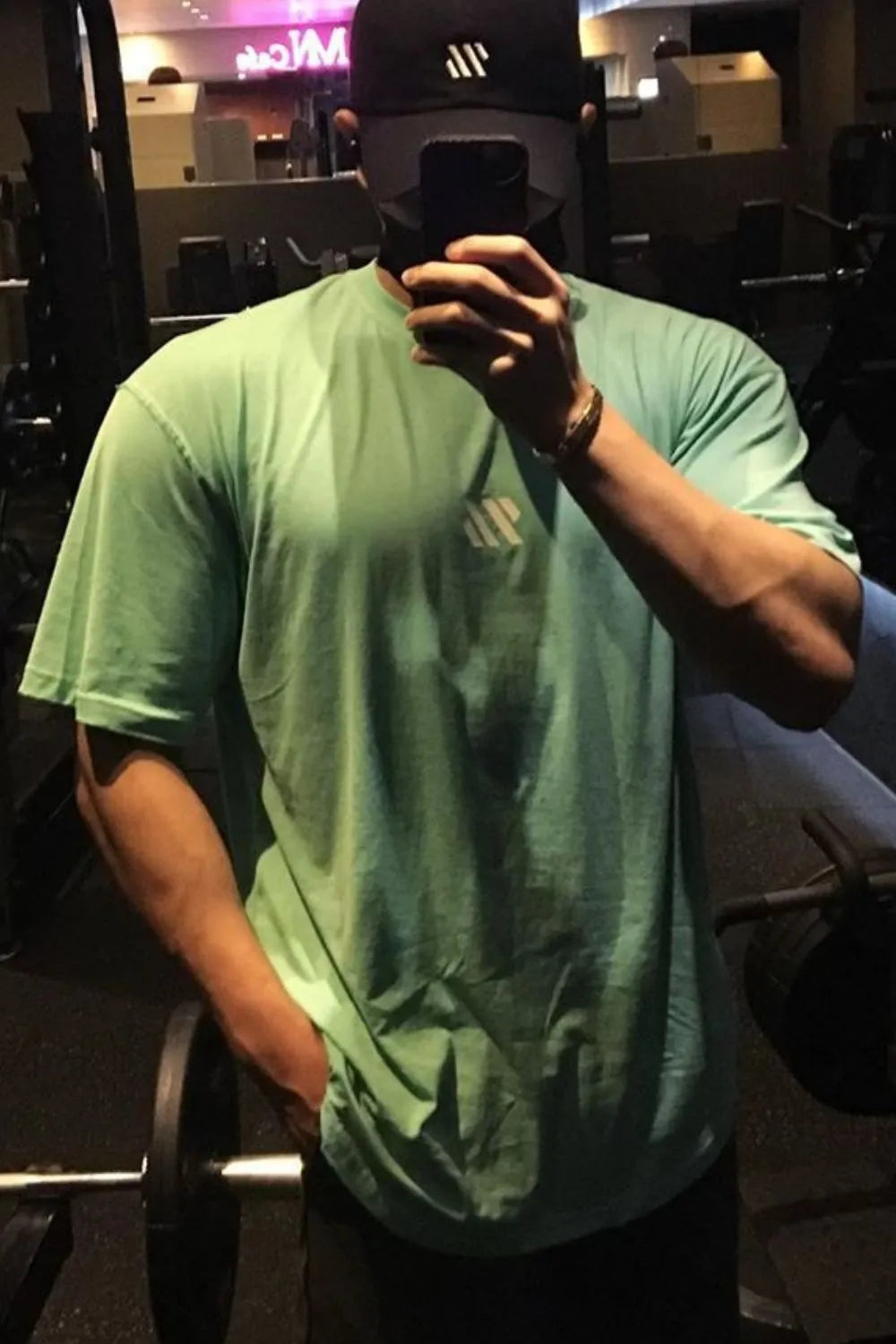 Oversized green t-shirt with white logo detail on chest, short sleeves, crew neck.