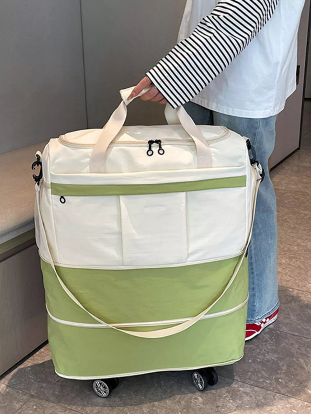 Premium large rolling duffel bag in white and green with dual handles and wheels.