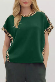 Green relaxed fit tee with leopard print accents on sleeves and sides.