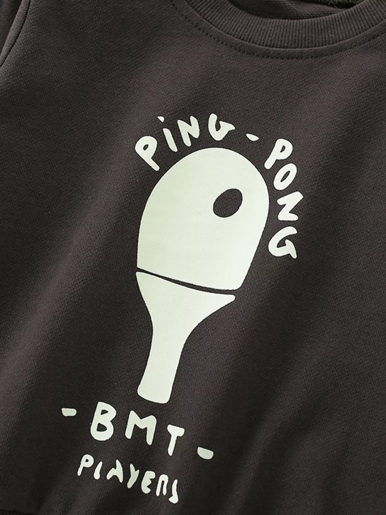 Coffee brown baby sweatshirt with white ping pong graphic and text.