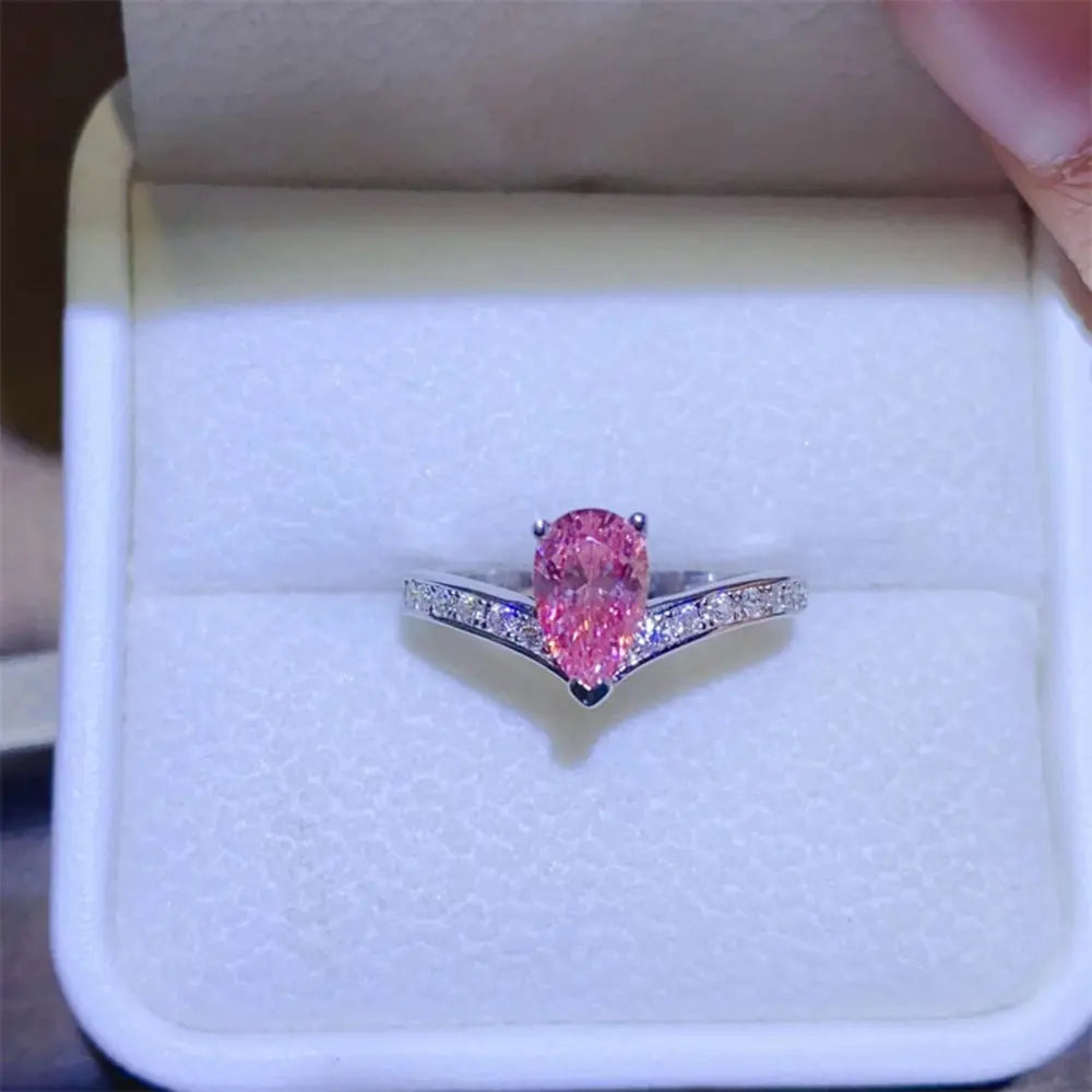 Silver chevron ring with pink pear-cut moissanite and diamond accents