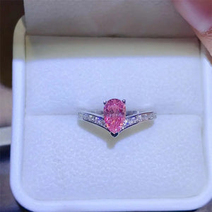 Silver chevron ring with pink pear-cut moissanite and diamond accents