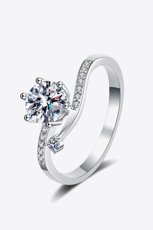 Silver moissanite bypass ring with pavé accents and a large center stone.
