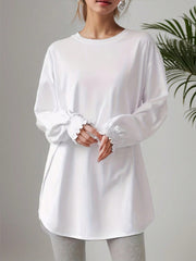 White oversized tunic top with ruffled cuffs and crew neck.