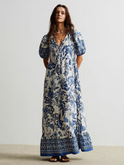 Charming floral maxi dress with tie-neck, puff sleeves, and ruffled hem.