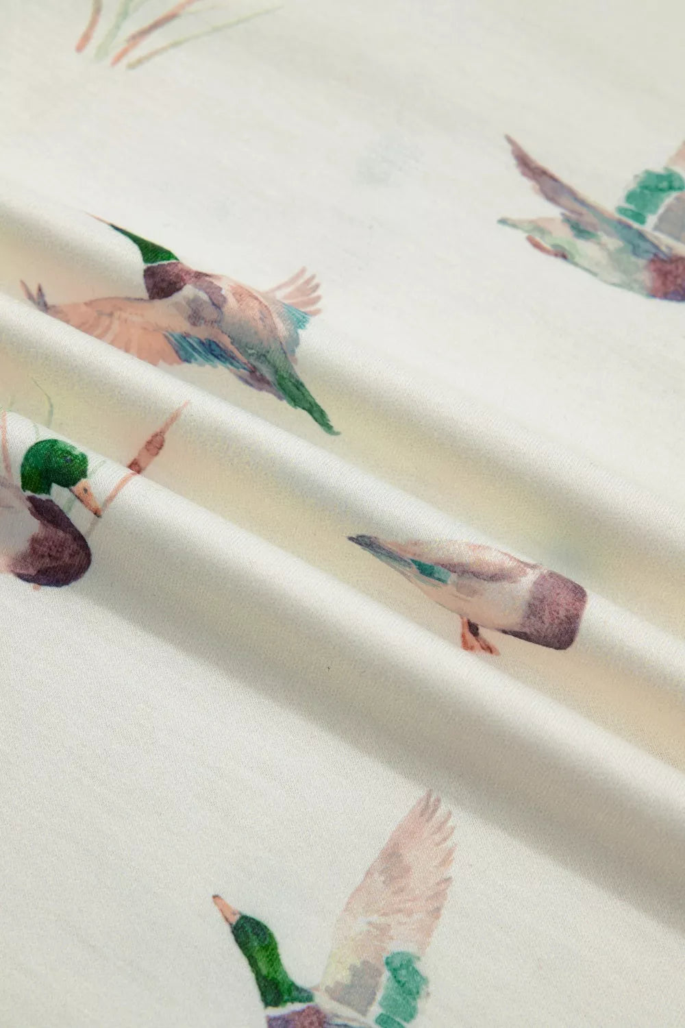 Cream tank top with a mallard duck print, featuring watercolor-style flying ducks.