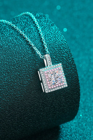 Silver moissanite halo pendant necklace with square-cut center stone and pink accent stones.