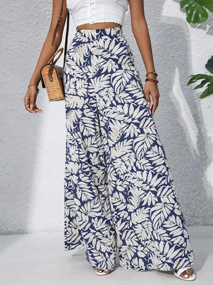 Palazzo trousers in blue with white tropical leaf print, made of 100% polyester.