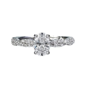 Sterling silver ring with oval moissanite and pave diamond band.