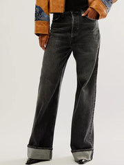Cuffed wide-leg denim trousers in black with a relaxed fit and visible cuffs.