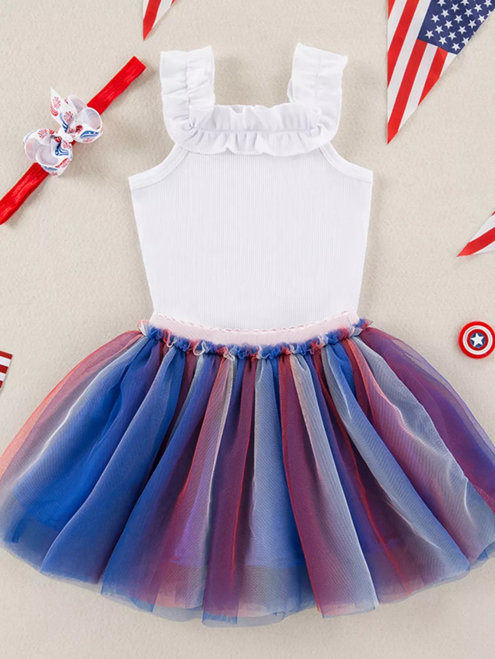 White ruffled neck baby tutu dress with red, white, and blue tulle skirt.