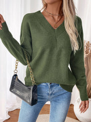 Army green V-neck knit sweater with a twisted back detail, long sleeves, and a relaxed fit.