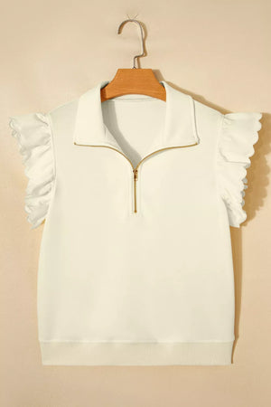 White cotton blouse with ruffled sleeves, stand-up collar, and gold zip.