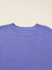 Purple knit sweater with crew neck and ribbed details.