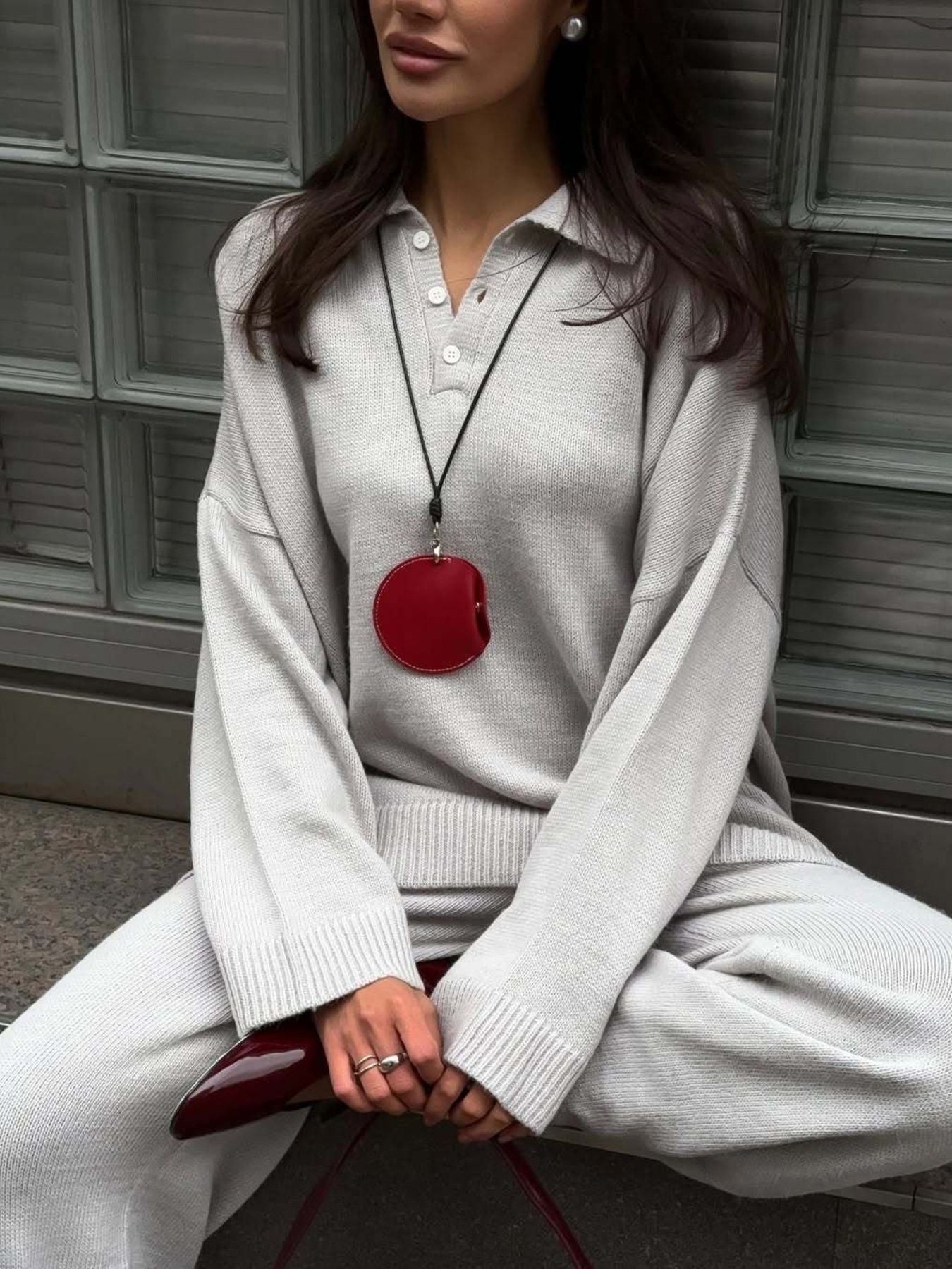 Grey knit polo sweater with button detail and wide-leg pants set.