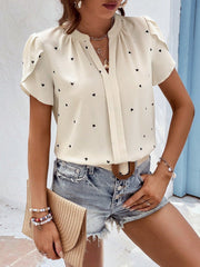 Cream heart print puff sleeve blouse with V-neck and ruffle sleeves.