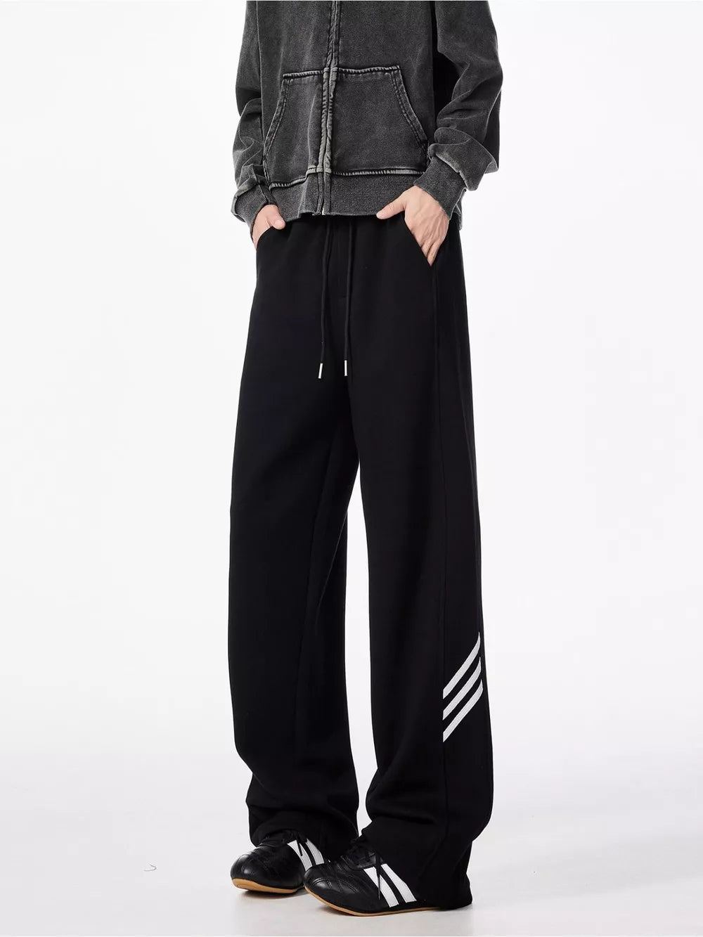 Black relaxed fit sweatpants with drawstring and side stripe detail