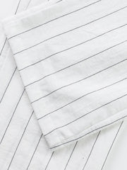 White men's sweatpants with thin black pinstripes and a wide-leg cut.