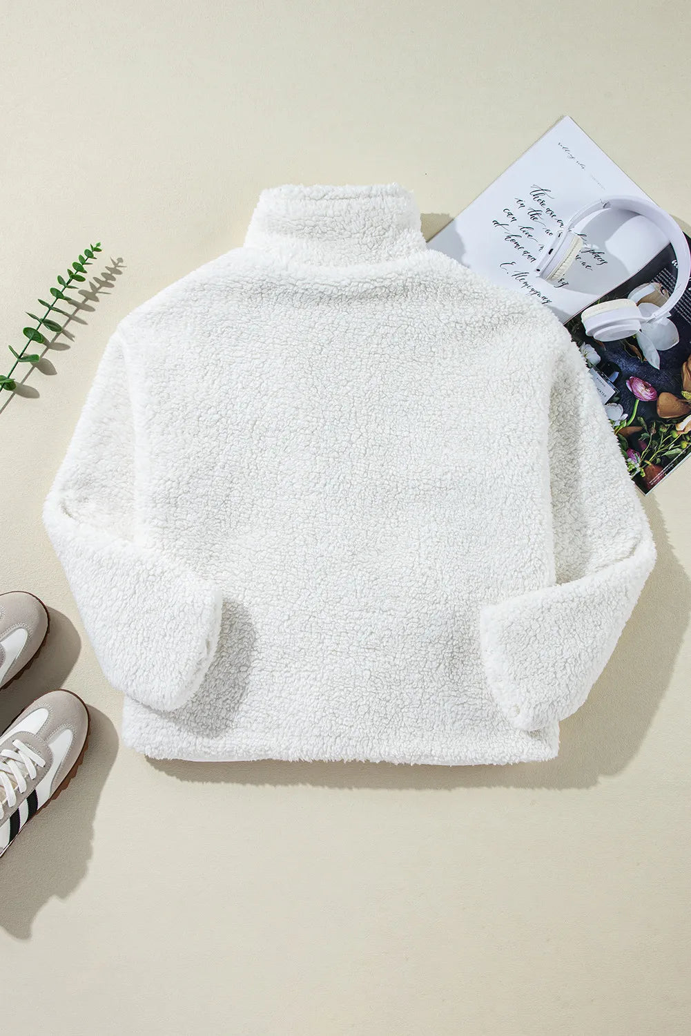 White teddy bear collarless jacket with high neck and long sleeves.