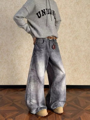 Men's vintage wash wide leg jeans in grey denim with curved seams.