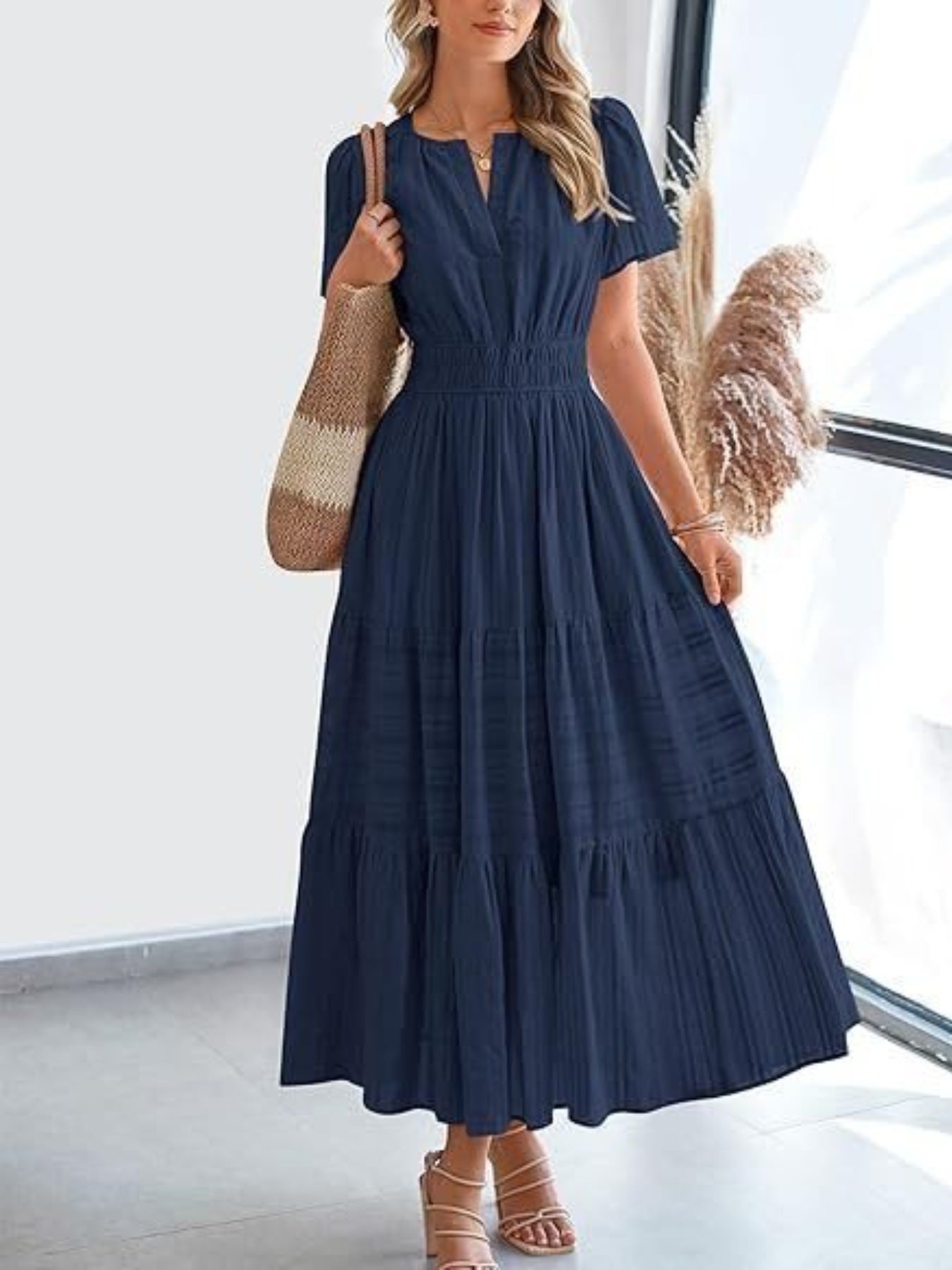 Dark navy V-neck tiered maxi dress with smocked waist and short sleeves.