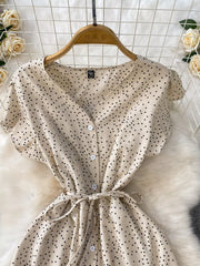 Apricot polka dot maxi dress with belt, button front, V-neck, short sleeves.