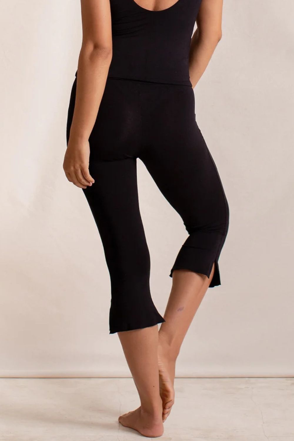 Black flared hem crop leggings with side slits at the hem.