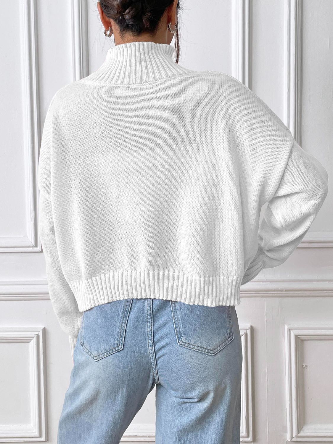 White cropped turtleneck knit sweater with ribbed cuffs and hem.
