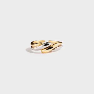 Two-tone gold and silver open ring with intertwined, fluid design.